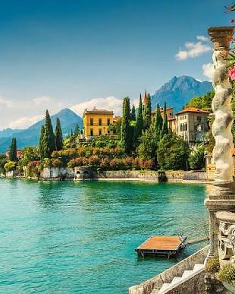 Vila histórica à beira do Lago di Como, cercada de flores e vegetação